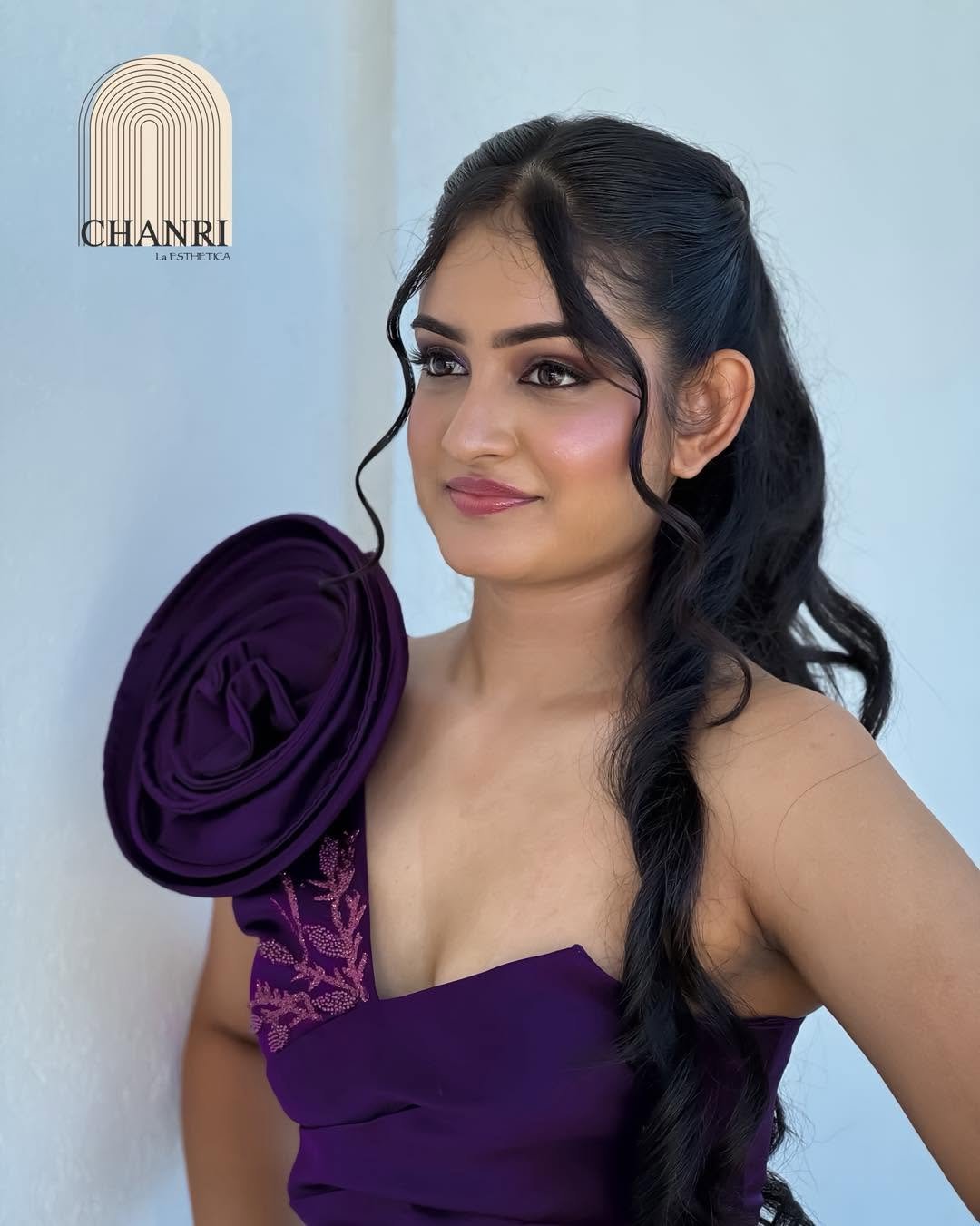 Evening styling with soft curls and purple gown by CHANRI