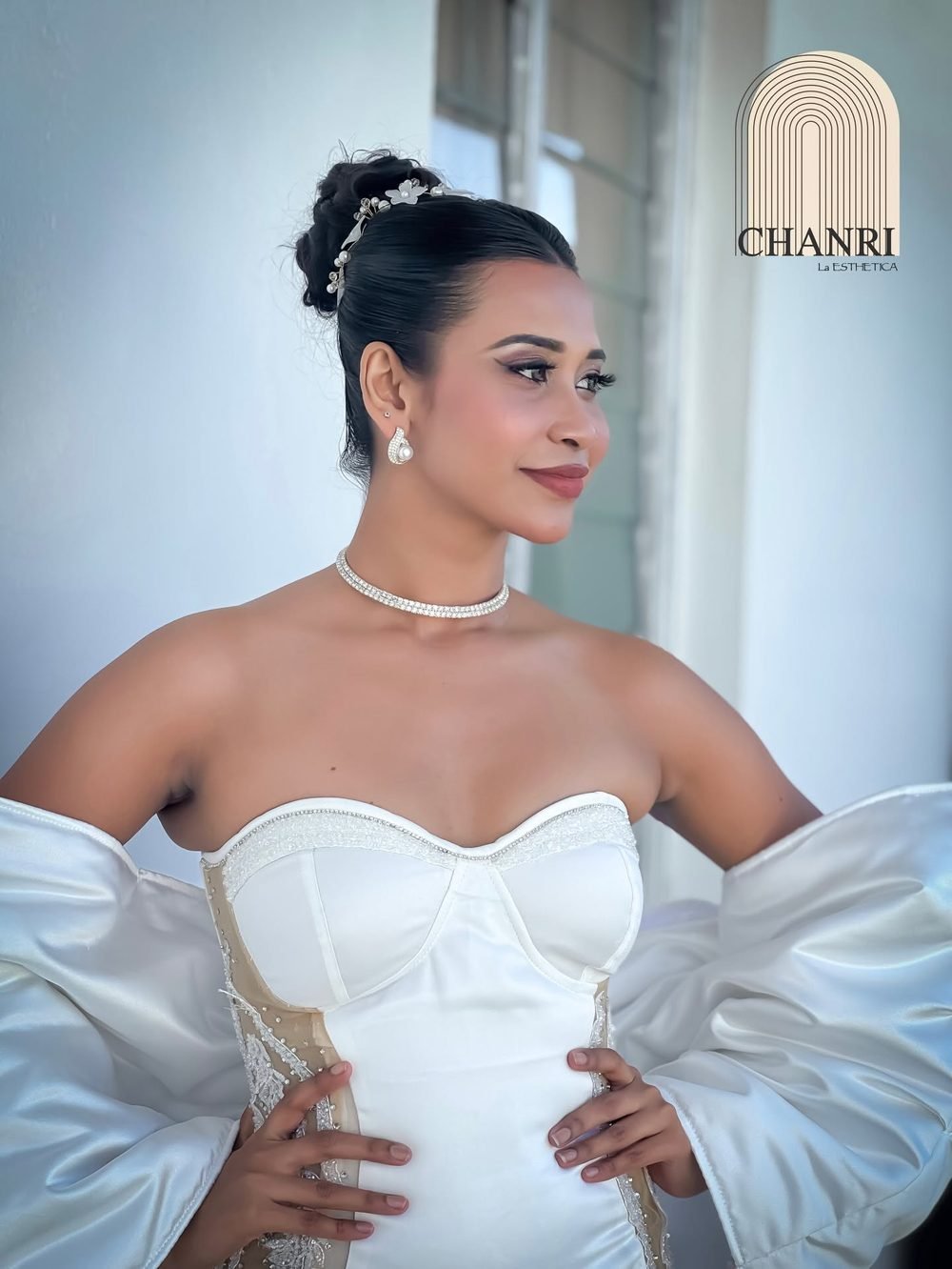 Bridal updo with pearl choker and white gown by CHANRI